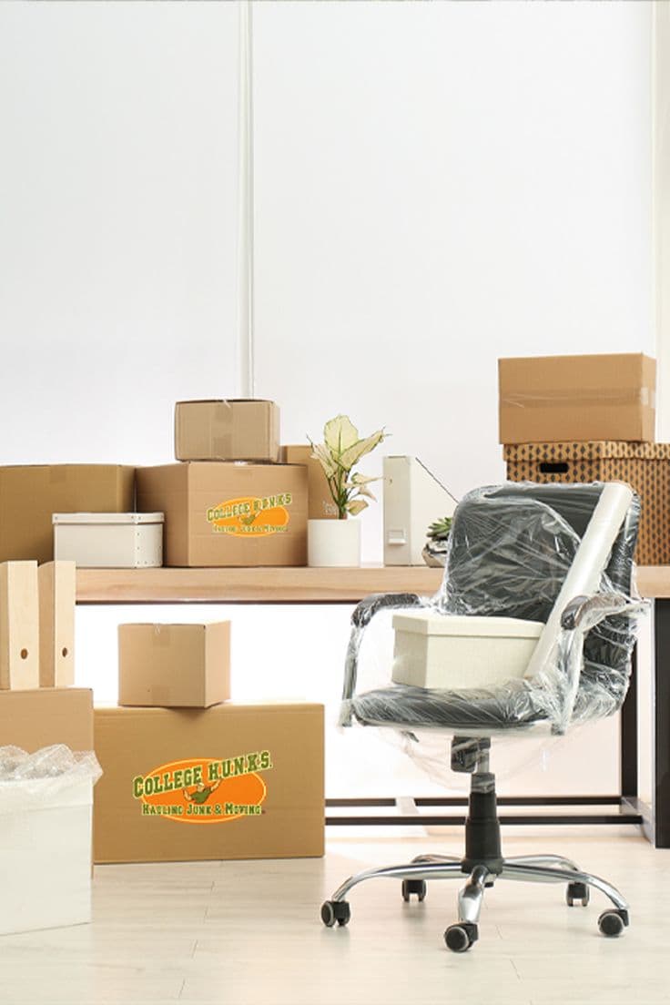 Office furniture and desks staged for a commercial move